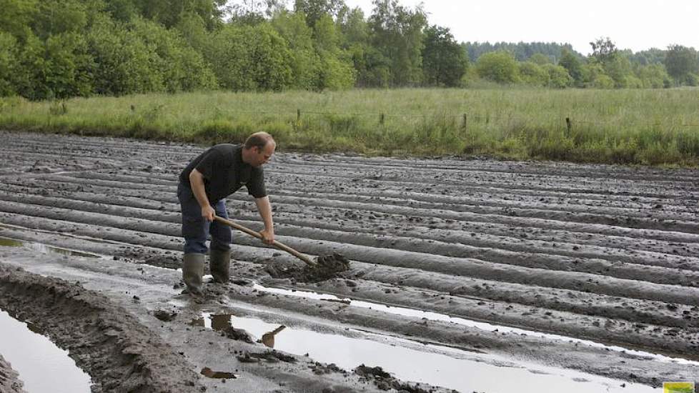 Meeuwissen graaft geulen om het water te laten weglopen.